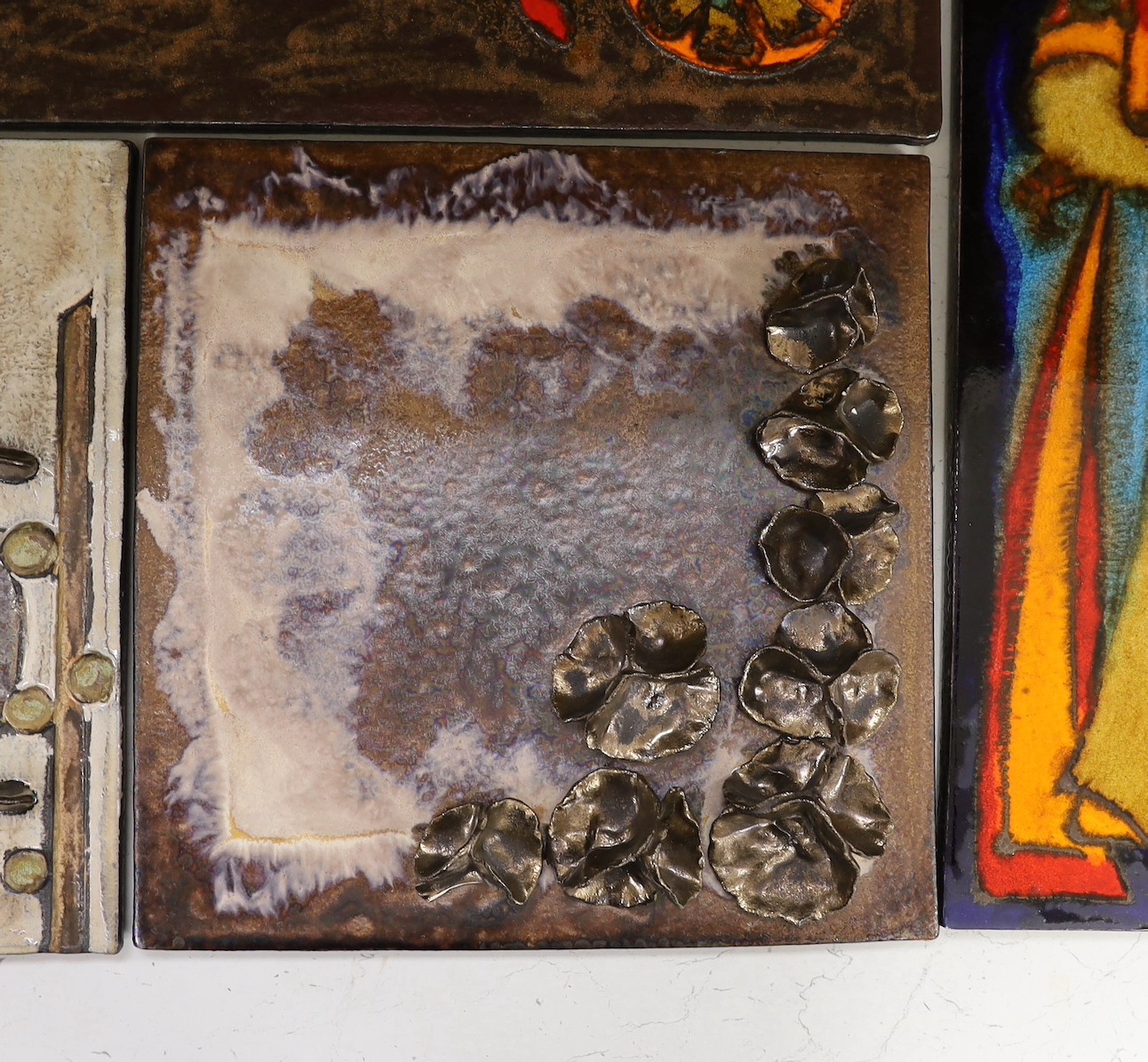Two West German Ruscha pottery wall plaques and two studio pottery metallic glazed plaques. Largest 35x60cm